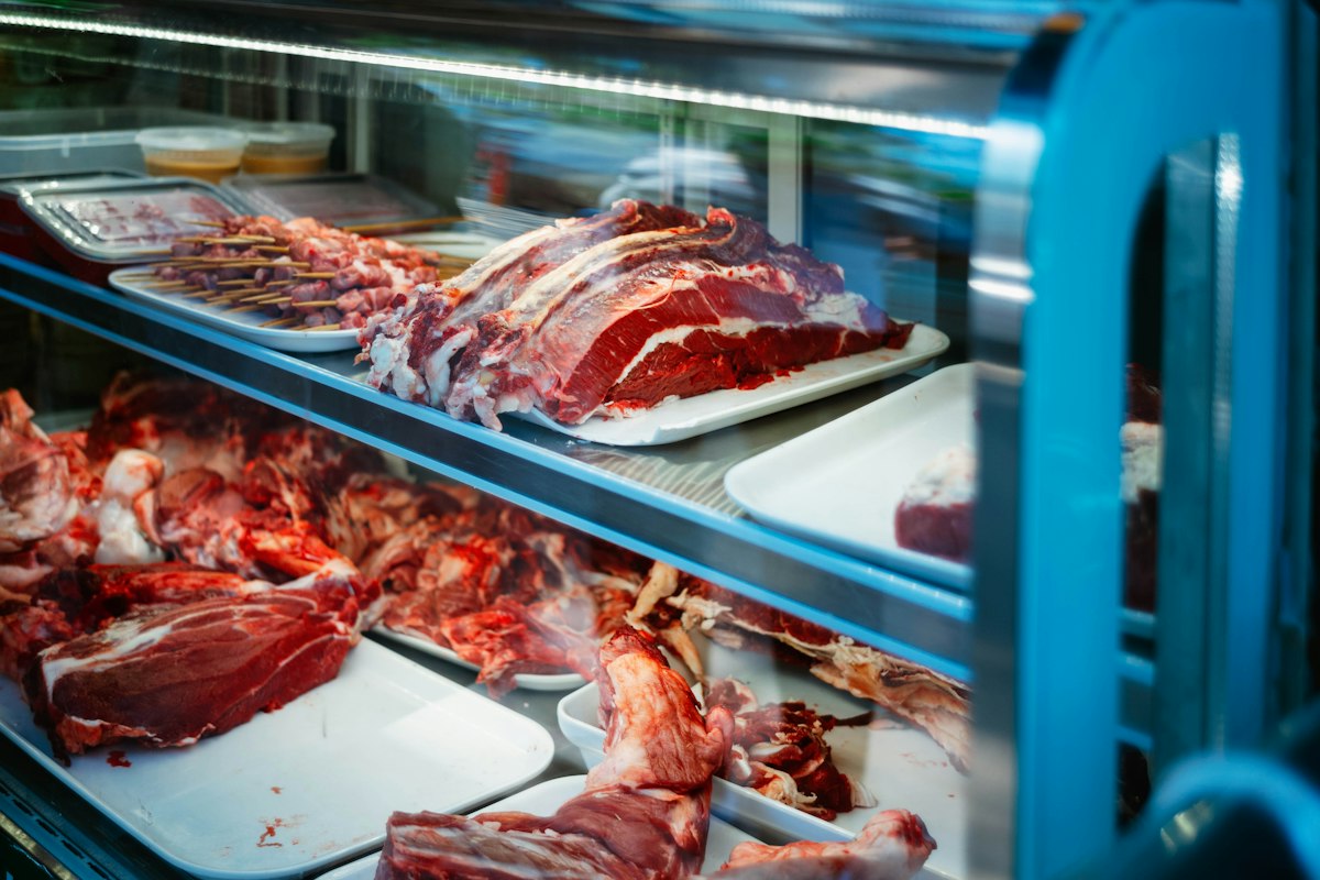 Fresh cuts of meat in a butcher display case
