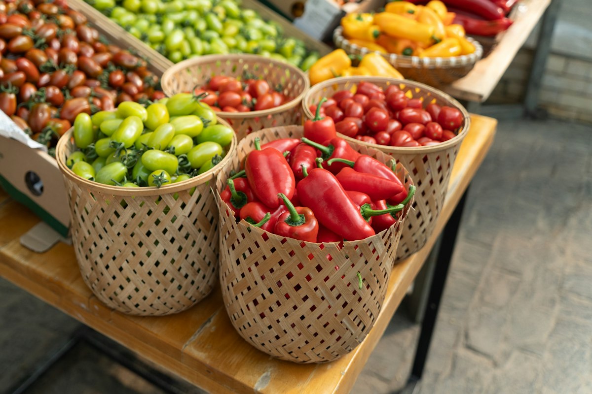Baskets of fresh peppers and tomatoes